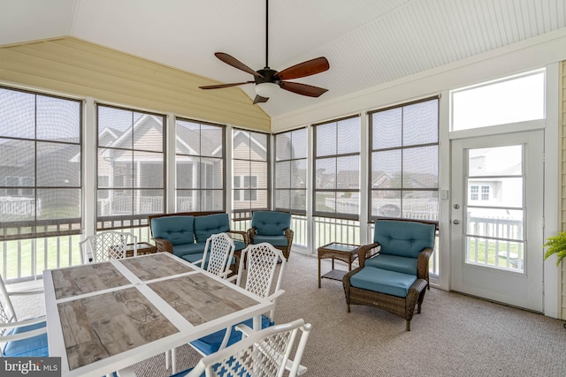 sunroom with lofted ceiling, carpet, and ceiling fan