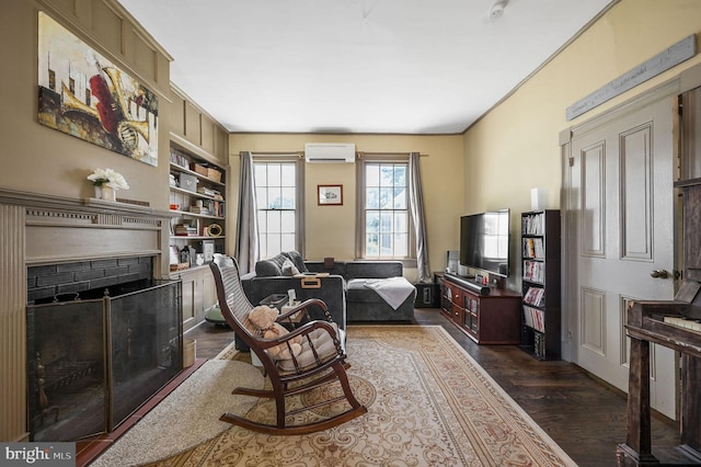 living room with an AC wall unit, a fireplace with flush hearth, built in features, and dark wood-style flooring