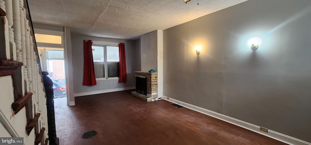 2641 N Bouvier St, Philadelphia, PA 19132 - interior space with dark wood-style flooring, a fireplace, visible vents, baseboards, and a textured ceiling