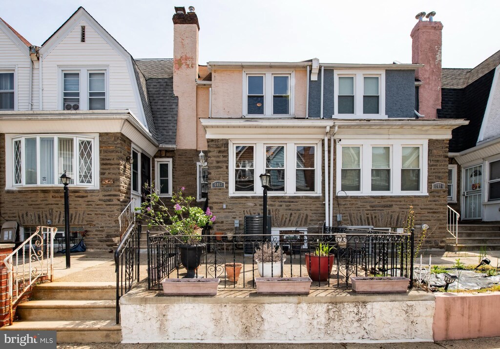 exterior space featuring a chimney, central air condition unit, and a shingled roof
