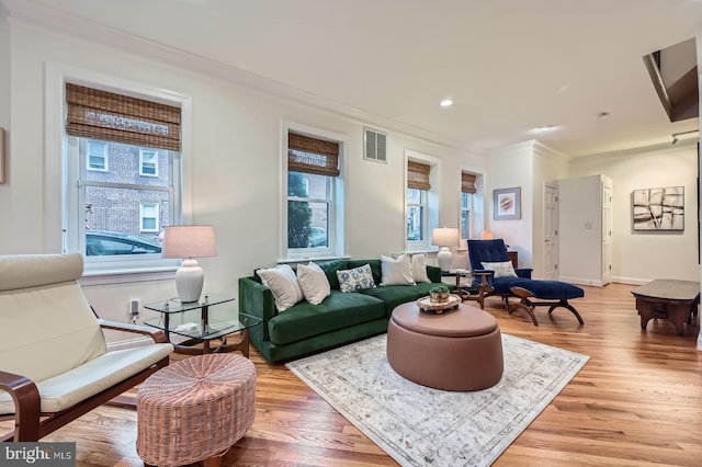 3223 Elliott St, Baltimore, MD 21224 - living room featuring crown molding, plenty of natural light, light wood-type flooring, baseboards, and recessed lighting