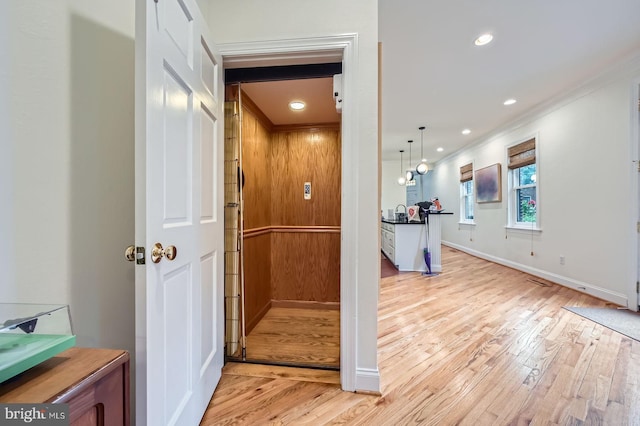 3223 Elliott St, Baltimore, MD 21224 - corridor with crown molding, light wood finished floors, baseboards, and recessed lighting