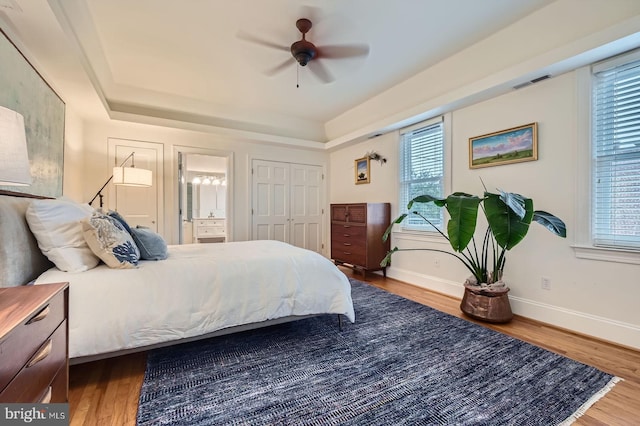3223 Elliott St, Baltimore, MD 21224 - bedroom with a raised ceiling, wood finished floors, and multiple windows