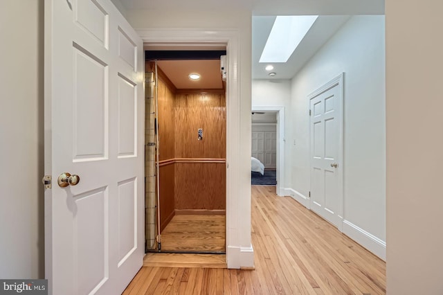 3223 Elliott St, Baltimore, MD 21224 - corridor featuring a skylight, light wood-style floors, baseboards, and recessed lighting