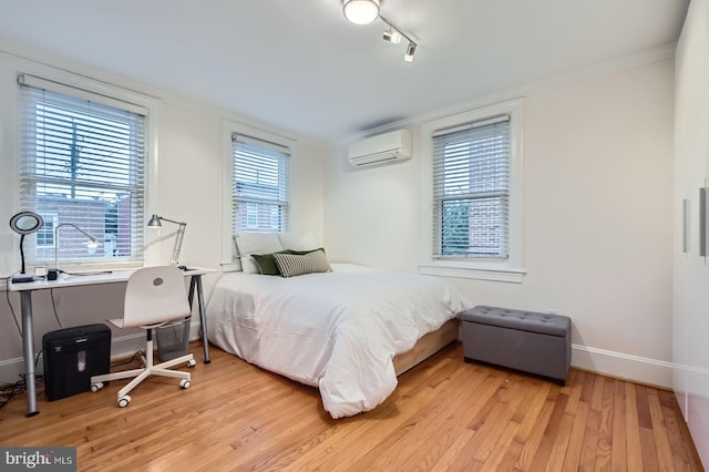 3223 Elliott St, Baltimore, MD 21224 - bedroom with a wall mounted AC, wood finished floors, baseboards, and crown molding