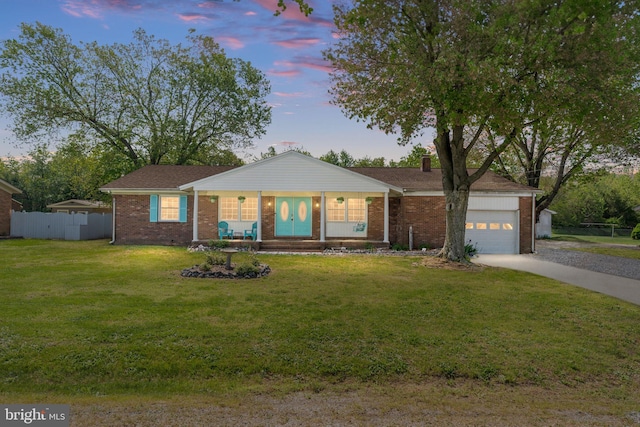 79 Darl Cir, Colonial Beach, VA 22443 - single story home with a yard, brick siding, fence, driveway, and an attached garage