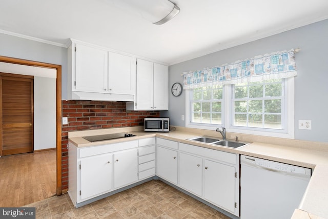 79 Darl Cir, Colonial Beach, VA 22443 - kitchen with stainless steel microwave, a sink, black electric stovetop, ornamental molding, and dishwasher