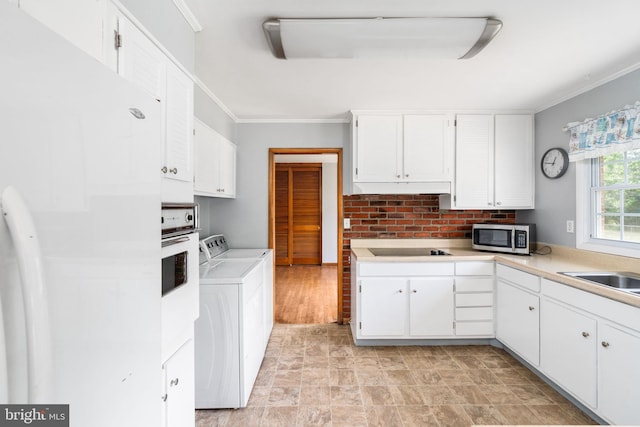 79 Darl Cir, Colonial Beach, VA 22443 - kitchen featuring white cabinets, washer and dryer, white appliances, and light countertops