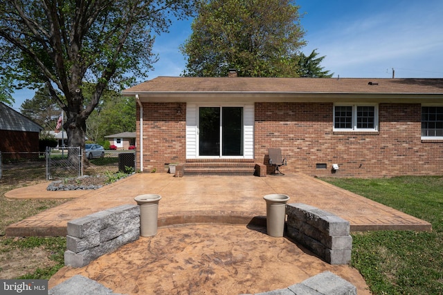 79 Darl Cir, Colonial Beach, VA 22443 - back of property with crawl space, brick siding, fence, and a patio area
