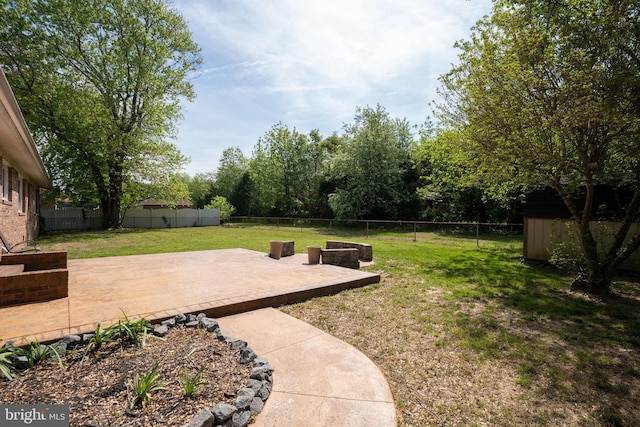 79 Darl Cir, Colonial Beach, VA 22443 - view of yard with an outbuilding, a patio, a storage unit, and a fenced backyard
