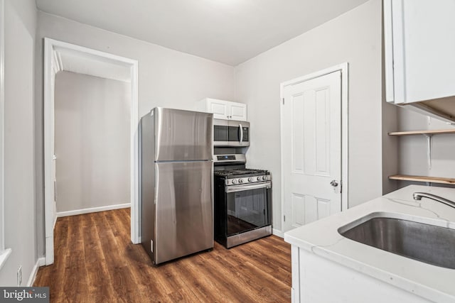 2227 Page St, Philadelphia, PA 19121 - kitchen with a sink, appliances with stainless steel finishes, light stone countertops, and dark wood-style floors