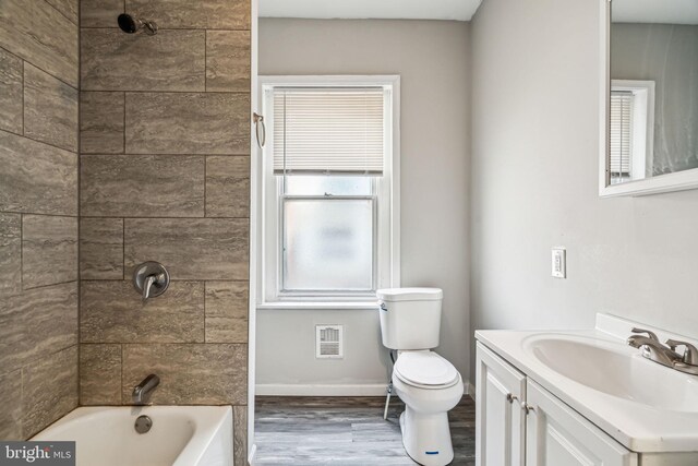 2227 Page St, Philadelphia, PA 19121 - full bathroom with visible vents, wood finished floors, vanity, baseboards, and toilet
