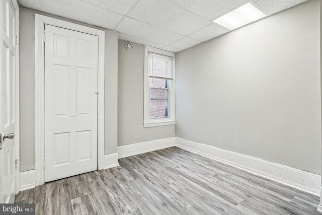 2227 Page St, Philadelphia, PA 19121 - unfurnished bedroom with baseboards, a drop ceiling, and wood finished floors