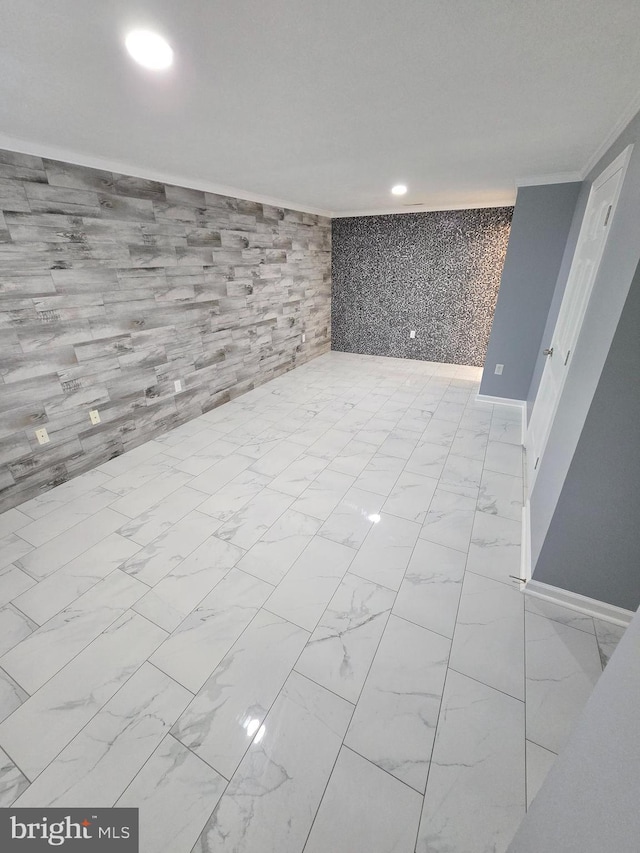 basement featuring recessed lighting, crown molding, marble finish floor, and baseboards