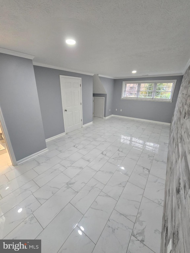 interior space with a textured ceiling, crown molding, and marble finish floor