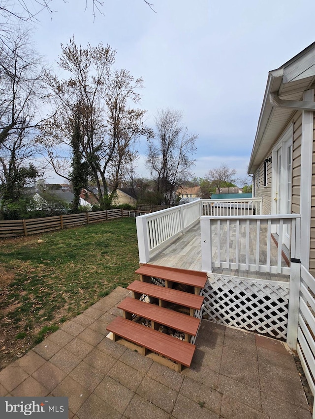 view of patio featuring a wooden deck and fence