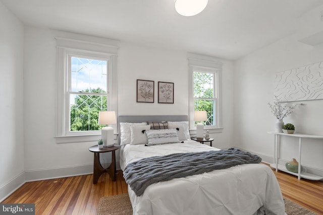 bedroom featuring baseboards and wood finished floors