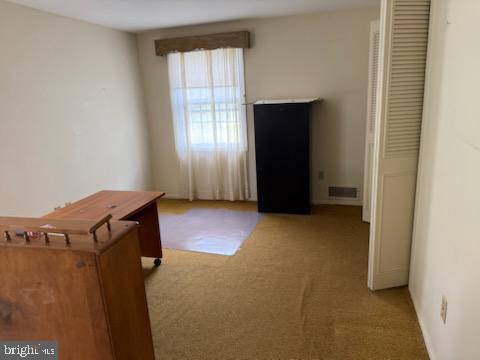 bedroom with carpet flooring and visible vents