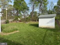 view of yard featuring an outbuilding and a shed