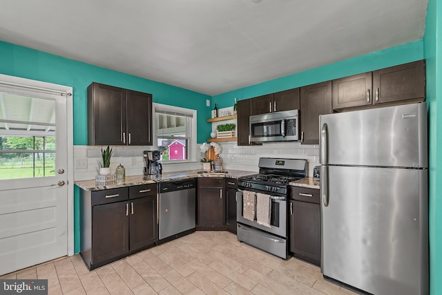 6842 Queens Ferry Rd, Baltimore, MD 21239 - kitchen with stainless steel appliances, decorative backsplash, dark brown cabinetry, open shelves, and light stone countertops