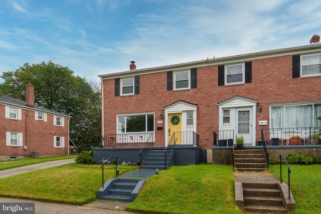6842 Queens Ferry Rd, Baltimore, MD 21239 - view of front of property with brick siding, a front yard, and a chimney