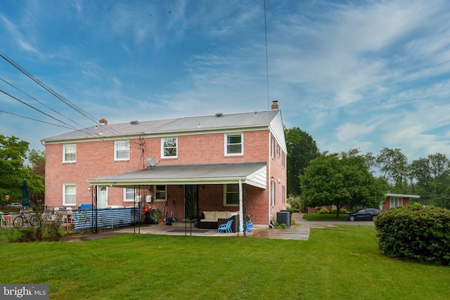6842 Queens Ferry Rd, Baltimore, MD 21239 - back of property featuring a patio area, a chimney, central AC unit, brick siding, and an outdoor hangout area