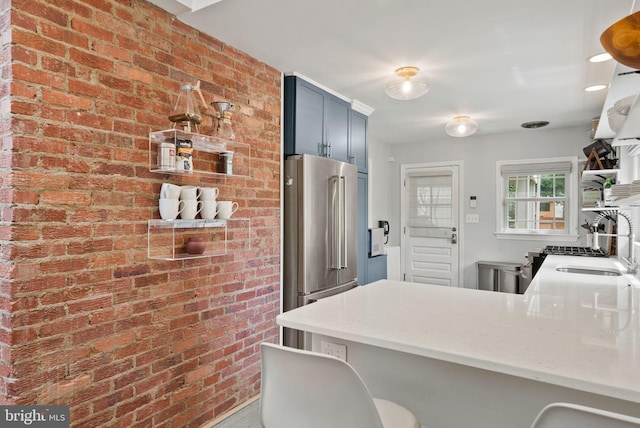 2006 Scroggins Rd, Alexandria, VA 22302 - kitchen featuring brick wall, a peninsula, high end fridge, and a sink