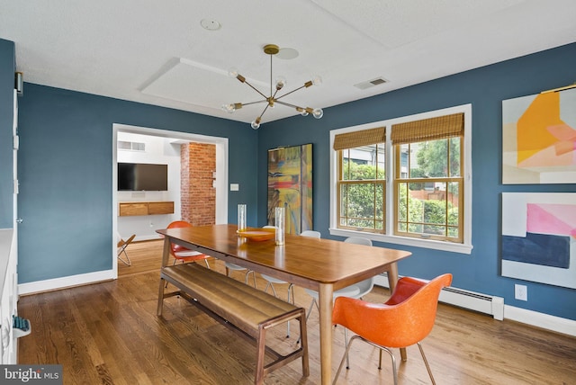 2006 Scroggins Rd, Alexandria, VA 22302 - dining room with baseboards, a baseboard heating unit, wood finished floors, and visible vents