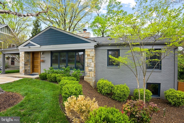 2006 Scroggins Rd, Alexandria, VA 22302 - view of front facade featuring brick siding, a chimney, and a front lawn