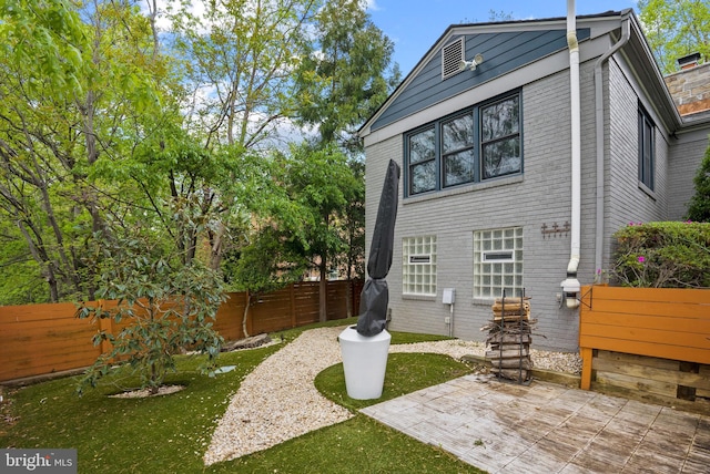 2006 Scroggins Rd, Alexandria, VA 22302 - rear view of property featuring a fenced backyard and a patio area