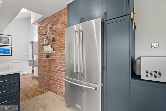 2006 Scroggins Rd, Alexandria, VA 22302 - kitchen with light countertops, brick wall, high end refrigerator, and light wood-type flooring