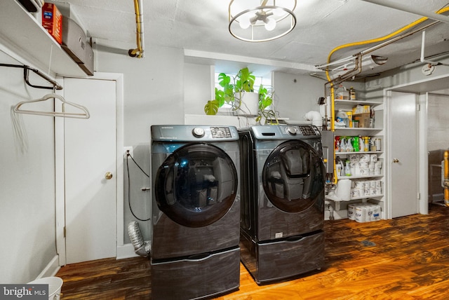 2006 Scroggins Rd, Alexandria, VA 22302 - clothes washing area featuring washing machine and clothes dryer, laundry area, and wood finished floors