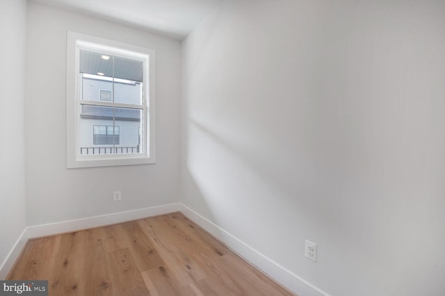 unfurnished room with light wood finished floors and baseboards