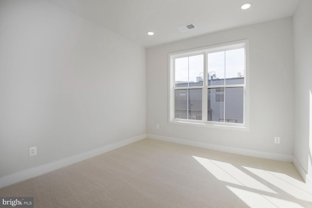 empty room featuring recessed lighting, visible vents, carpet floors, and baseboards