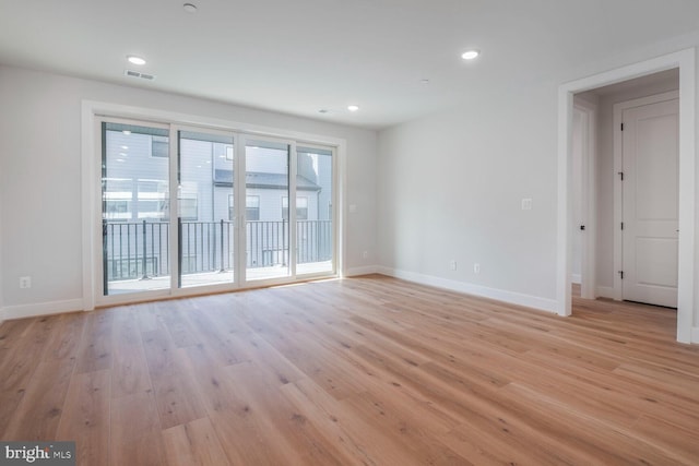 spare room featuring light wood finished floors, recessed lighting, visible vents, and baseboards