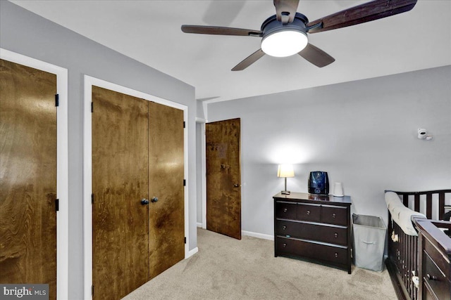 carpeted bedroom featuring baseboards and ceiling fan
