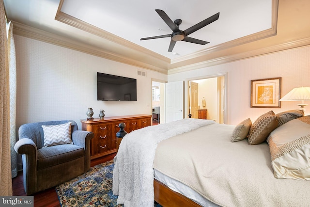 bedroom with crown molding, visible vents, wallpapered walls, a raised ceiling, and dark wood finished floors