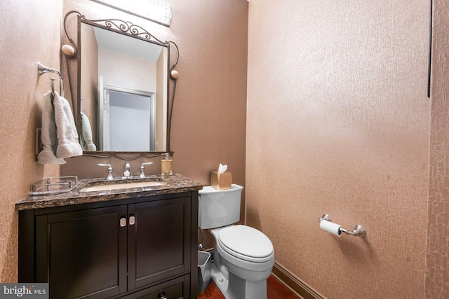 half bath featuring toilet and vanity