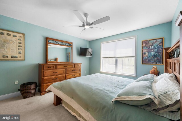 bedroom featuring carpet floors, a ceiling fan, and baseboards