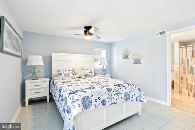 bedroom featuring baseboards, visible vents, ceiling fan, and light tile patterned flooring