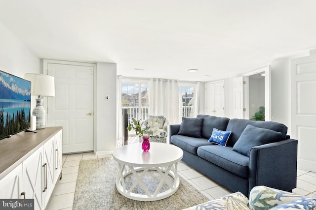 living room featuring baseboards and light tile patterned flooring