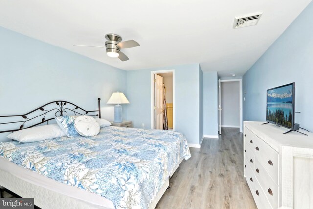 bedroom with baseboards, visible vents, ceiling fan, and light wood-style floors