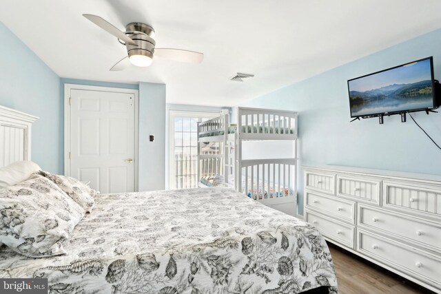 bedroom with dark wood-style flooring, ceiling fan, and visible vents