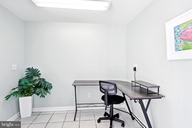 home office with light tile patterned floors and baseboards