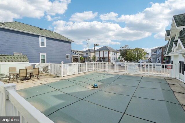 community pool featuring a residential view, fence, outdoor dining space, and a patio area