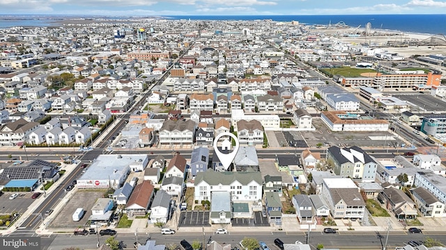 drone / aerial view featuring a residential view and a water view