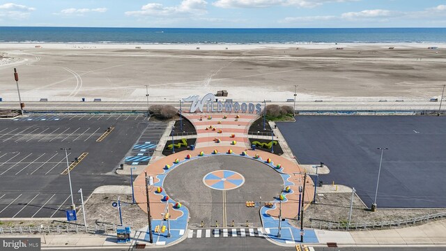 bird's eye view featuring a beach view and a water view