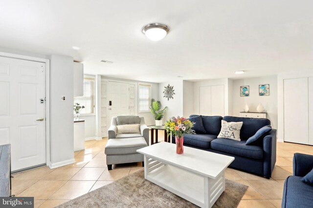 living room featuring light tile patterned floors and baseboards