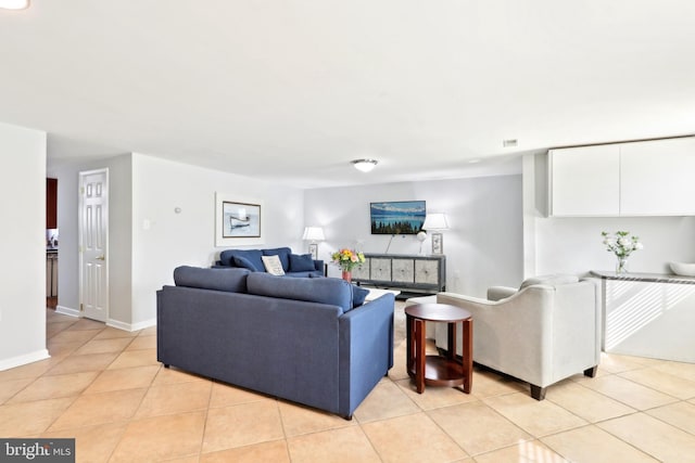 living area featuring light tile patterned floors and baseboards