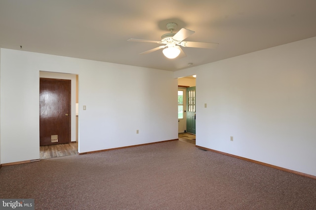 unfurnished room with baseboards, carpet flooring, and ceiling fan